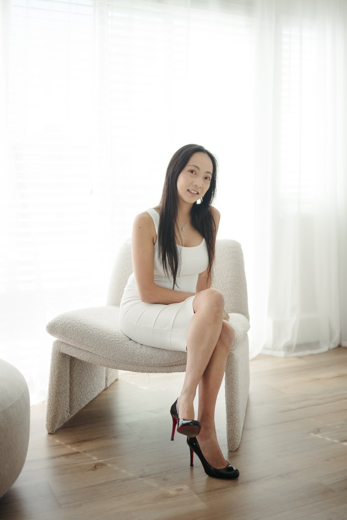 Dr. Tammy Chu seated in a bright, sunlit consultation room
